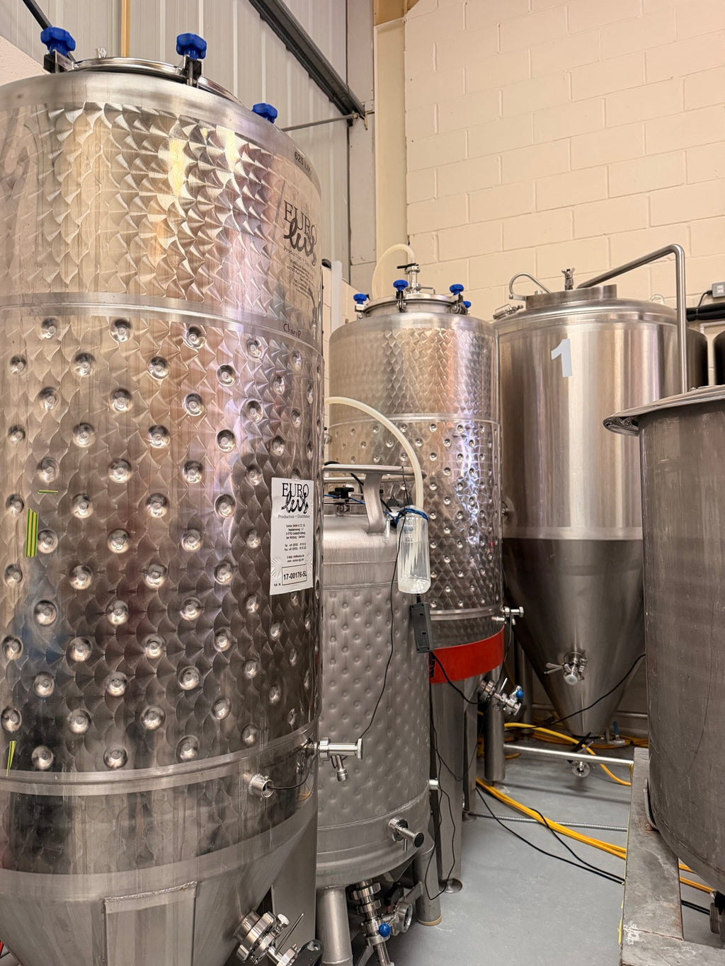 Stainless steel fermentation tanks in our Bishop's Stortford brewery, where the beer ferments before bottling
