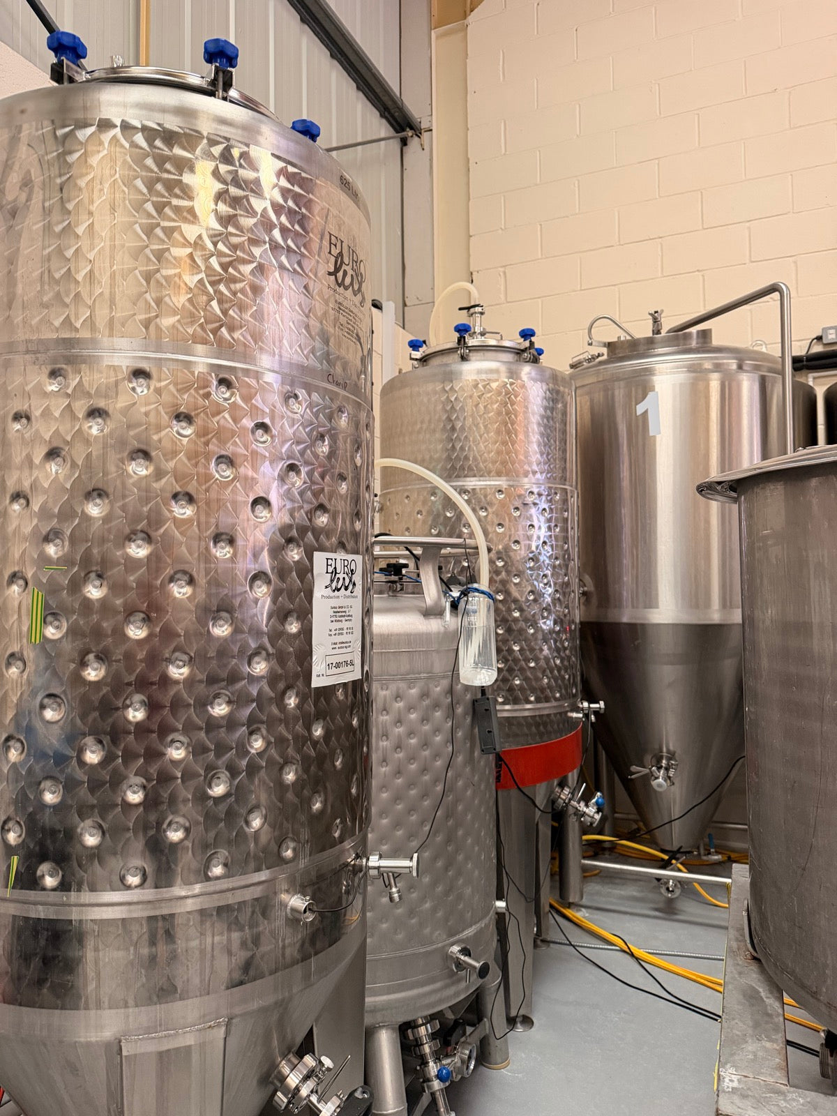Stainless steel fermentation tanks in our Bishop's Stortford brewery, where the beer ferments before bottling